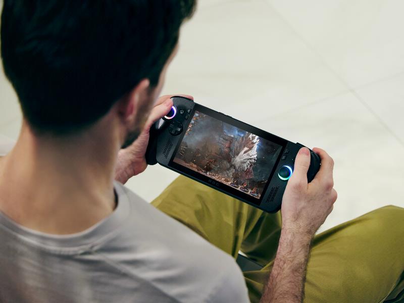 An over the shoulder image of a man playing on an ROG Ally handheld